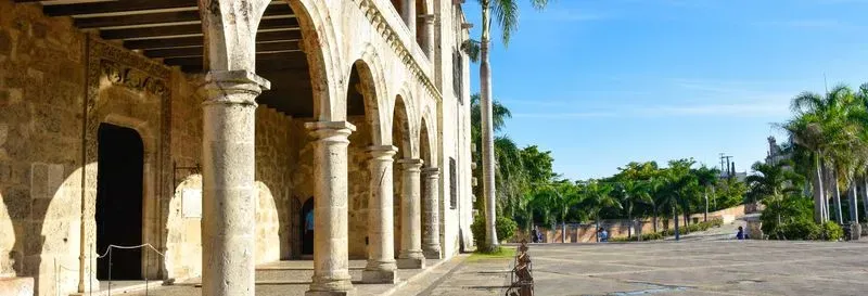 Discover the heritage of one of the oldest cities in the Caribbean and follow in the footsteps of Christopher Columbus with this excursion to Santo Domingo. Itinerary At the agreed time, you will be picked up from your hotel in Punta Cana and depart for Santo Domingo. First, after meeting your guide, you will visit the spectacular Los Tres Ojos cave to see the famous freshwater lakes and its incredible cavern. Do they hide a secret? You will find out! Then, you will approach the Columbus Lighthouse, where the famous explorer is said to rest. The next stop will be the Presidential Palace. You will observe this large-scale neoclassical architectural complex from the outside and continue your visit through the city's historic center, the magnificent Colonial Zone of Santo Domingo! You will enter the Cathedral of Santa María de La Encarnación, the first cathedral in America and the oldest on the continent, to discover its hidden secrets. You will travel back in time walking along Calle de las Damas, where you will see the first stone house built in the New World. You will visit the interior of the National Pantheon where the remains of illustrious historical figures of the Dominican Republic rest. You will continue walking to Plaza de España to see its beautiful terraces, offering an impressive view of the Ozama River. On this esplanade stands the famous Alcazar de Colon, the former residence of the Admiral, and you won't be able to stop yourself from taking photos when you visit its interior! You will then head to a restaurant in the historic center, where you will recharge with a delicious buffet lunch consisting of typical dishes such as rice, meat stews and beans. The menu also includes soft drinks. After recharging, you will head to the Malecón area to enjoy a superb view of the Caribbean Sea. Finally, you will be driven back to your hotel, with arrival scheduled between nine and eleven-thirty hours after pick-up. Temporary Closures The Alcázar de Colón is closed on Mondays. On this day, you will take a panoramic tour of the exterior. If the Alcazar is closed on other days, this part of the tour will be replaced by a visit to the Museum of the Royal Houses, one of the cultural monuments of Dominican history. Furthermore, some museums are closed on Mondays for maintenance. In this case, you will only be able to see the exterior. How does it work? During this excursion, you will follow a detailed itinerary to discover Santo Domingo. Starting from your hotel, you will set out to explore major historical sites with a guide. Buffet lunch is included, as is access to the main attractions. Note that the Alcázar de Colon is closed on certain days, but the tour will then be adapted. A transport service is also provided for the return to your hotel. Included: Pick-up from your hotel and return Professional guide Visits to the main attractions Buffet lunch with soft drinks Not included: Alcoholic beverages Personal expenses Meeting place: Your pick-up will take place directly at the entrance of your hotel in Punta Cana.